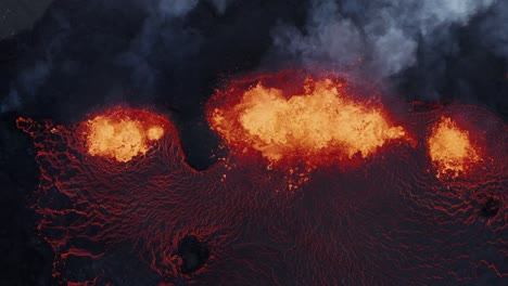 Molten-lava-spewing-from-active-fissure-volcano-in-Iceland,-2022,-top-down-aerial