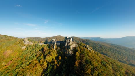 smooth, ascending fpv rotation around aggstein in stunning autumn light