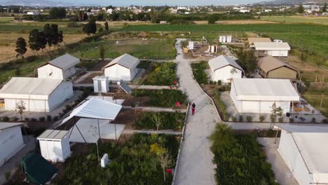 cinematic drone shot of a glamping site in costructiong in a greek island