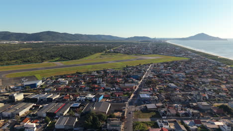 panorama view of the navegantes international airport with suburban neighborhood stretching toward the coastline, navegantes, santa catarina, brazil