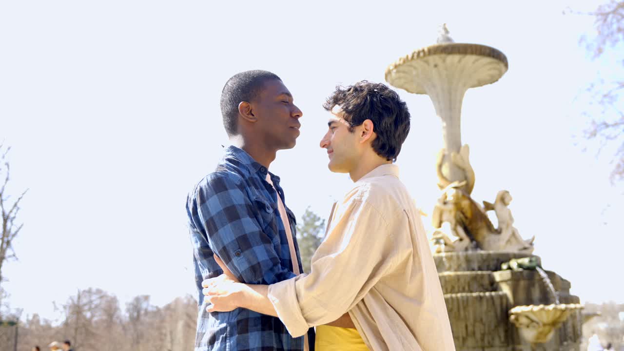 Two men in love hugging each other in a park