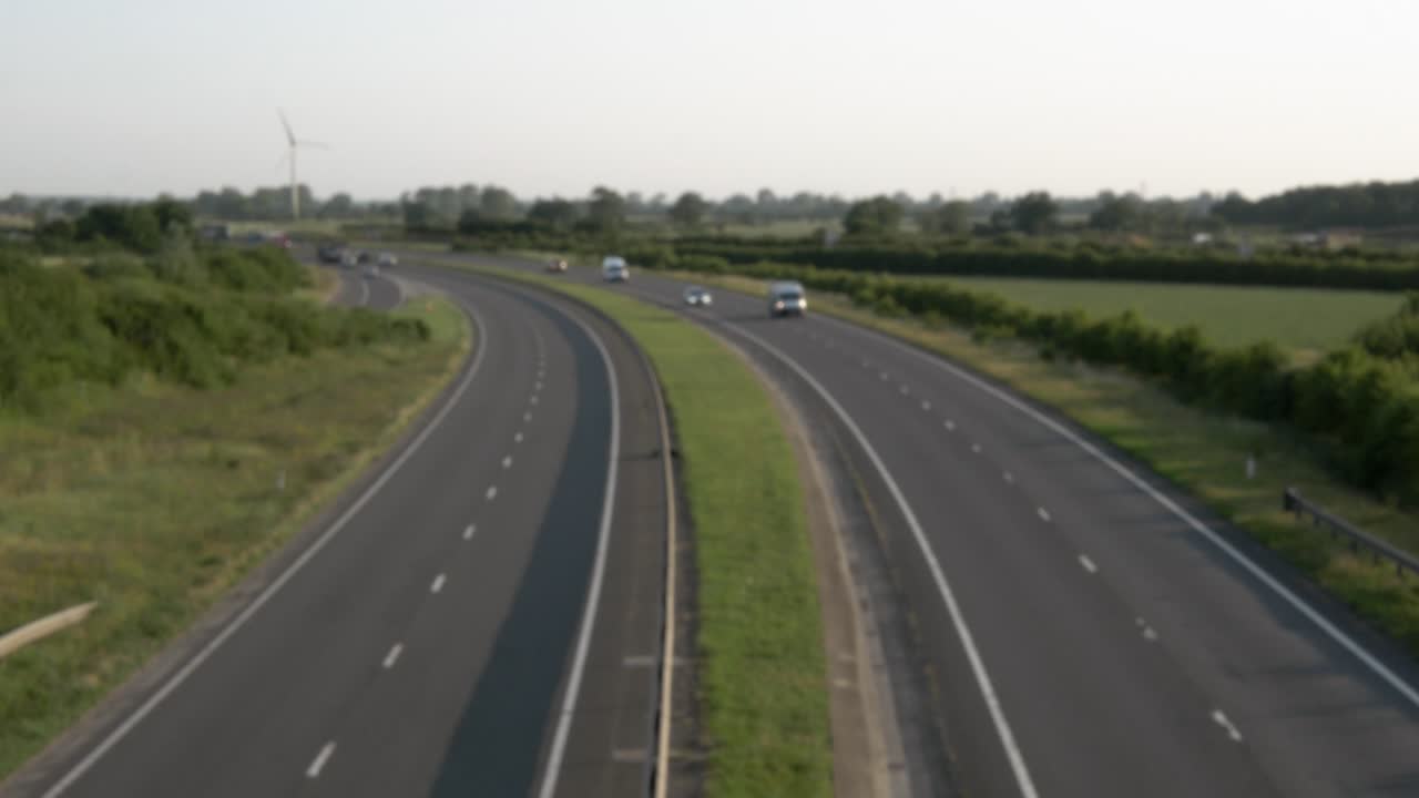 Out of focus background of highway traffic at sunrise. Lincolnshire England