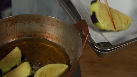 a japanese chef taking out deep fried kamonasu from oil at home kitchen, tokyo, japan