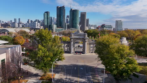 drone shot approaching the princes' gates from above, with the cn tower and the toronto city skyline in view