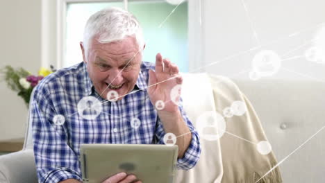 animation of connected icons, senior caucasian man waving hello and giving thumbs up on video call