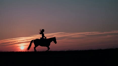woman riding horse at sunset