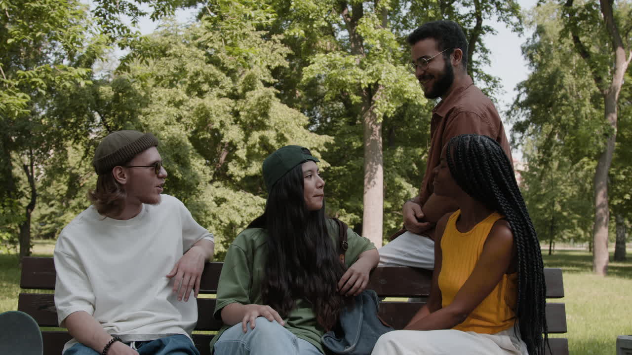 Diverse Group of Friends Chatting on a Park Bench