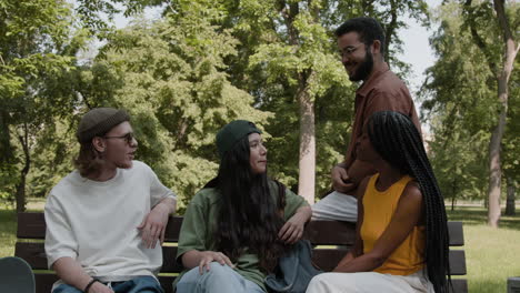 diverse group of friends chatting on a park bench