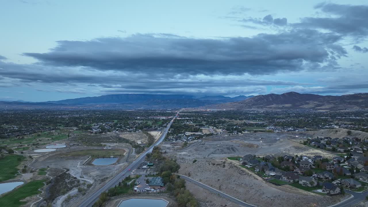 Dramatic Clouds Over The Mountains Surrounding Alpine At Dawn In Utah, USA. Sliding Aerial Shot