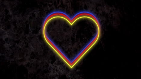 animation of red yellow and blue neon hearts flashing on dark wall