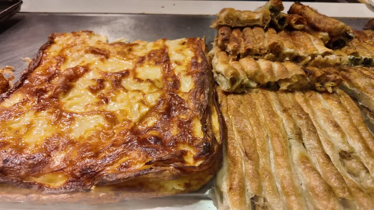 Assorted Golden Baked Pastries and Burek on a Tray