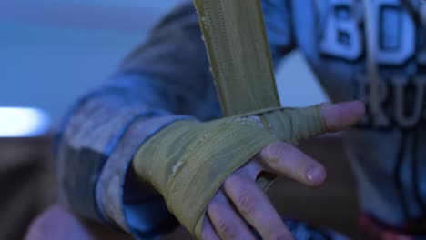 person wrapping hands with boxing hand wraps