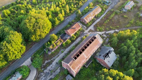 aerial footage of derelict coal mining buildings in the woods