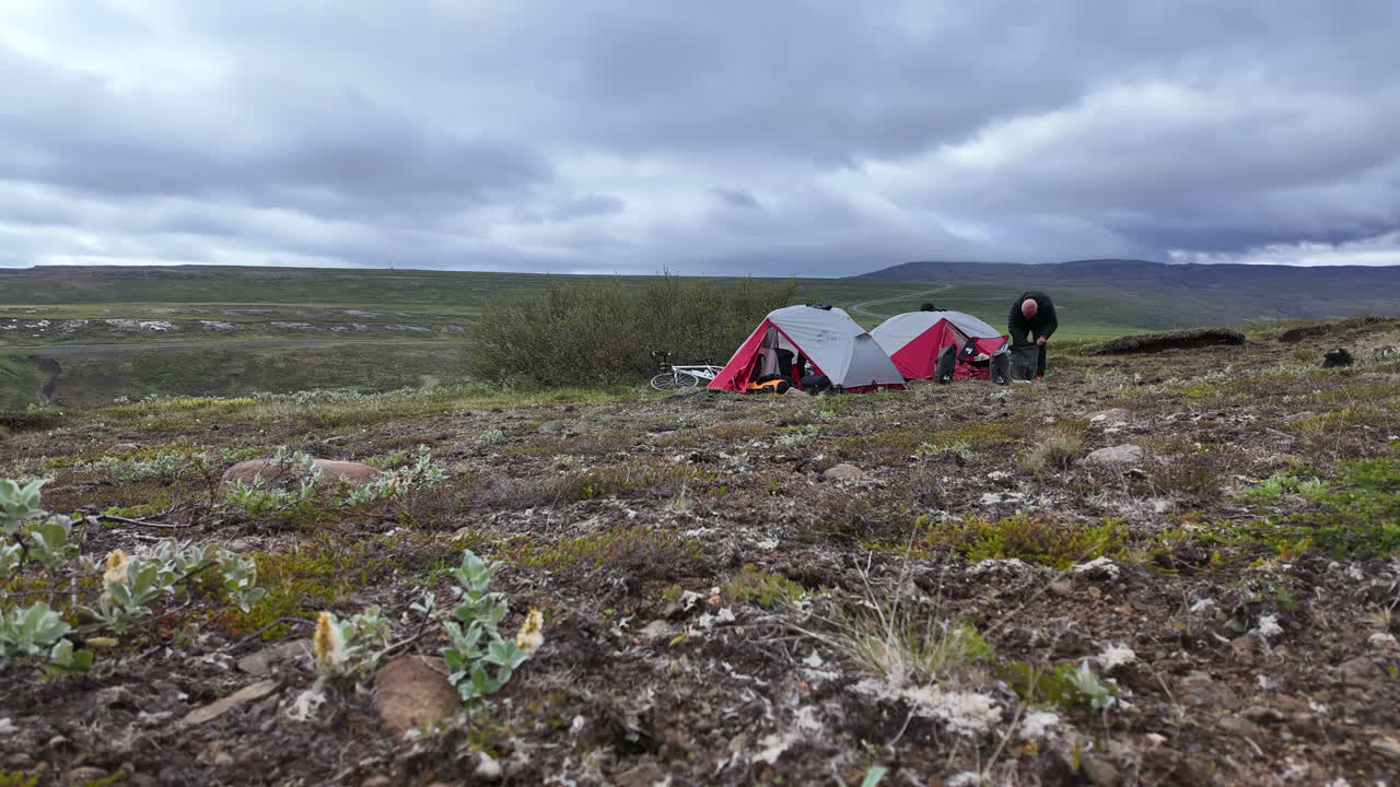 Dynamic timelapse showing two individuals efficiently wrapping up their camp near Brúarásskóli in Egilsstaðir, Iceland, against the backdrop of Iceland's stunning eastern landscapes