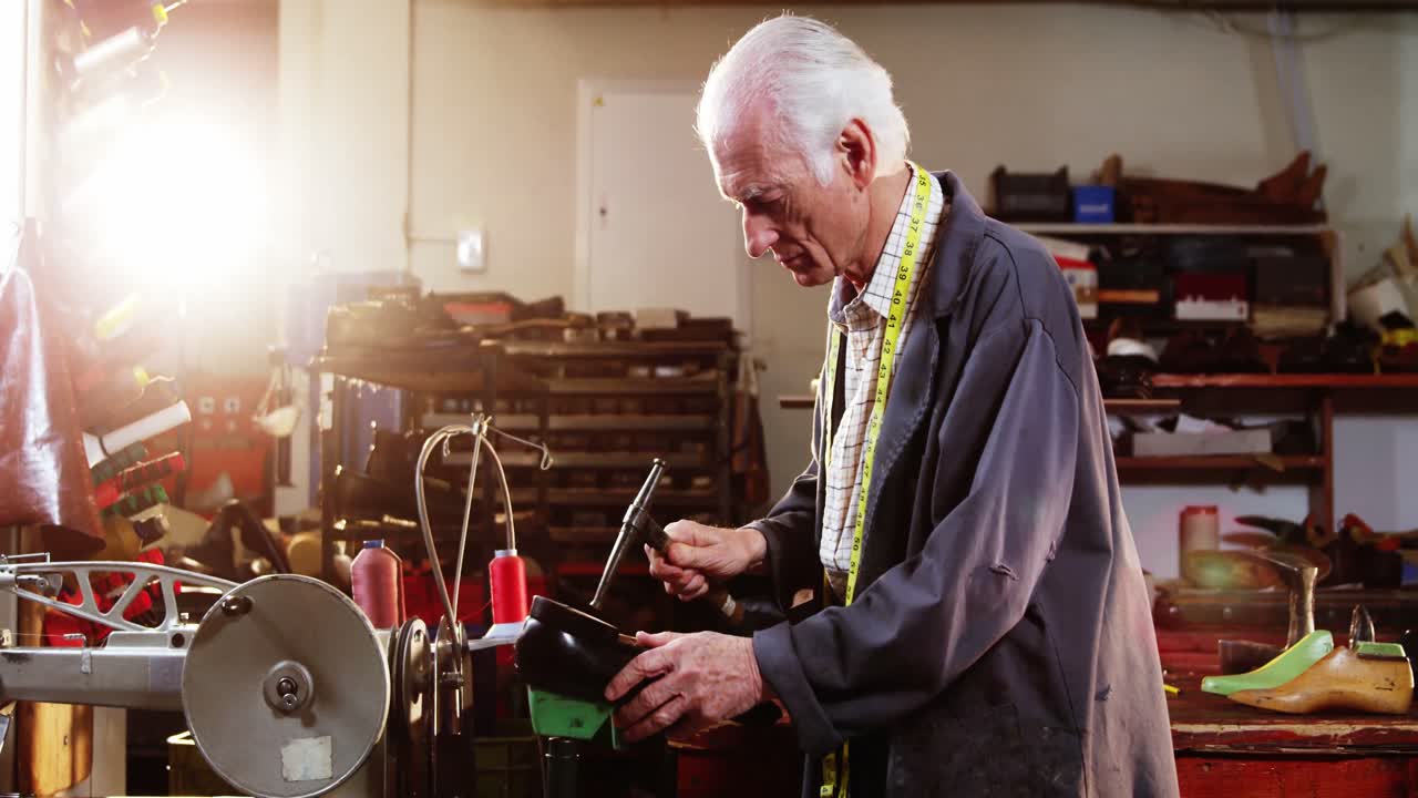 Shoemaker hammering on a shoe