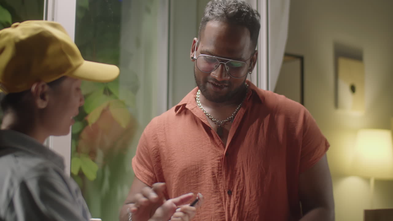 Man Receiving Parcel from Female Courier