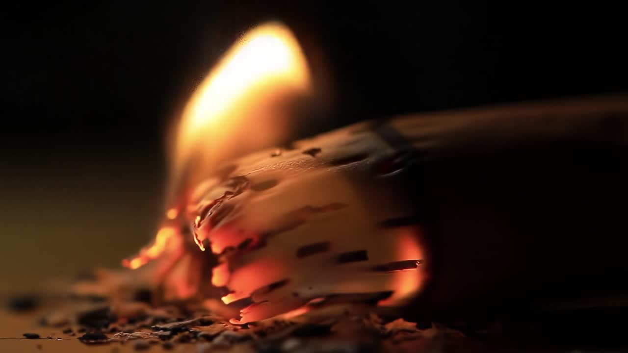 Glowing Ember Catches Fire as Wood Ignites Indoors During Evening Hours