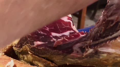 close up shot of chef cutting carefully fresh raw red meat