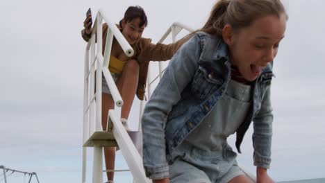 Low-angle-view-of-a-Caucasian-and-a-mixed-race-girl-enjoying-together