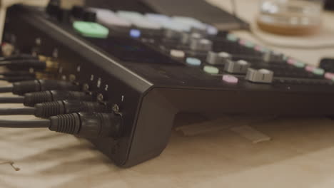 detail shot of a hand removing the xlr cable from a sound mixing console