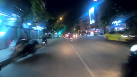 night driving through city streets in southeast asia