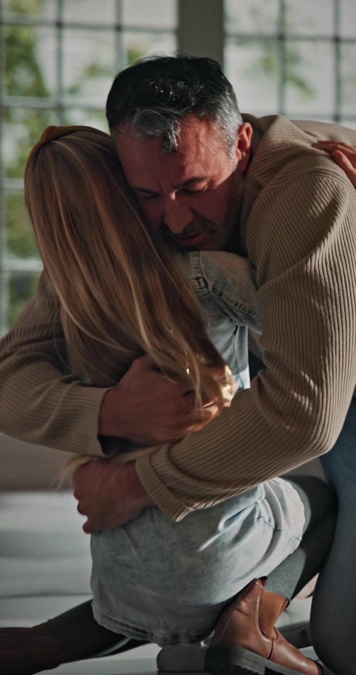 Father Embracing His Daughter in a Warm Home Setting