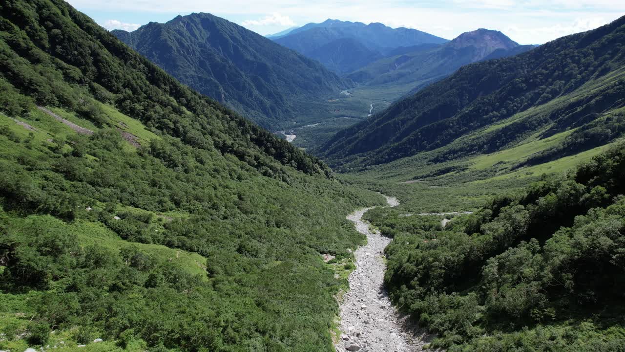 Rocky Valley Through The Mount Hotaka With Green Forest In Chubu-Sangaku National Park In Japan. - aerial pullback shot