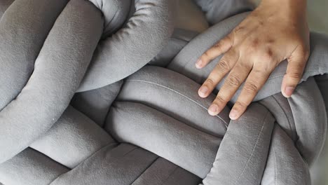 grey knotted fabric pillow