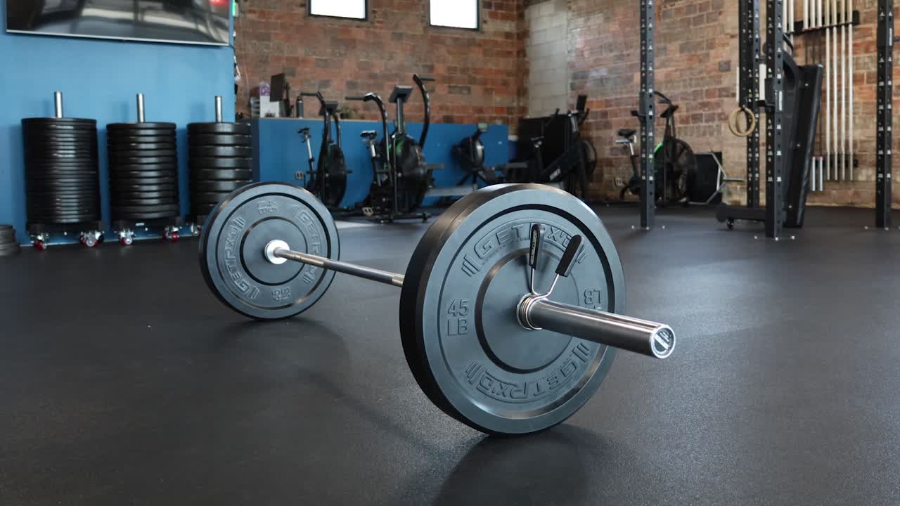 Barbell with weighted plates at gym