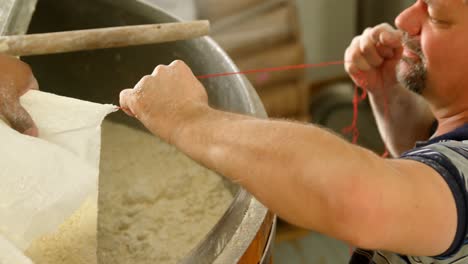 Male-workers-preparing-gin-in-distillery-4k