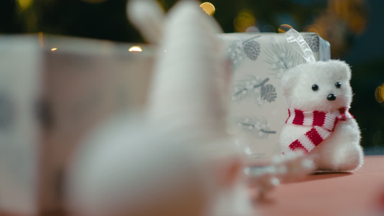 Christmas teddy bear next to a children's gift