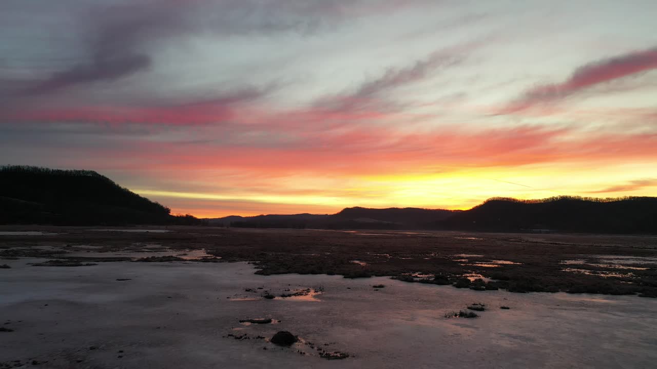 Colorful Sunset Sky Reflected on Icy Winter Landscape