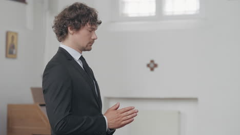 man praying in church