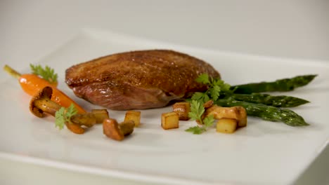 gourmet duck with roasted vegetables and mushrooms elegantly plated for fine dining