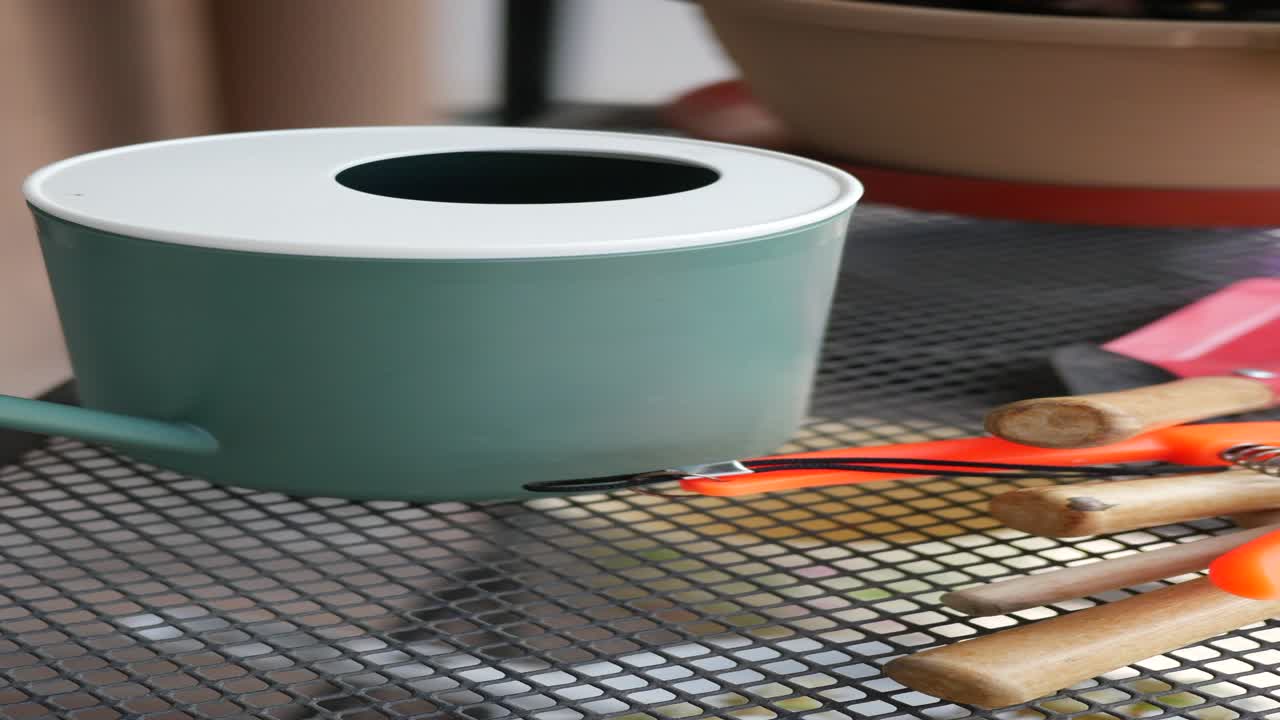 Watering can and gardening tools on a mesh table