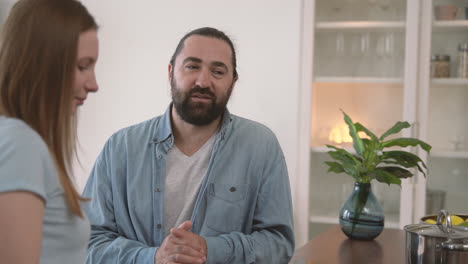 bearded man has an interesting conversation with a young woman