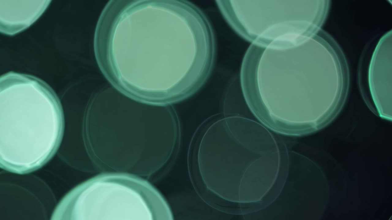 Abstract bokeh lights in soft focus, creating a dreamy atmosphere. Captured from a low angle