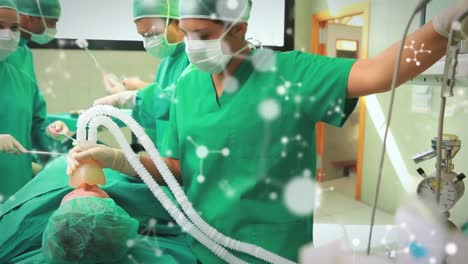 Animation-of-molecules-over-caucasian-surgeons-with-face-masks-during-surgery