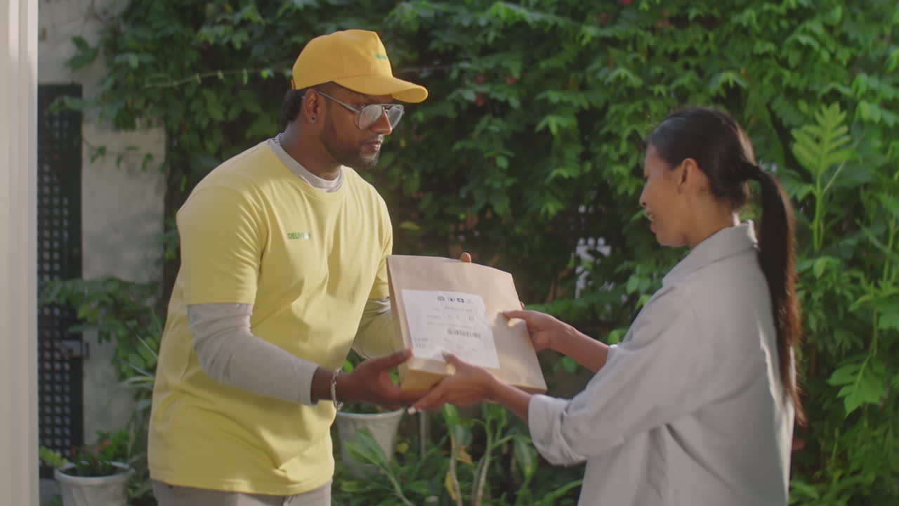 Woman Receiving Parcel from Courier at Home
