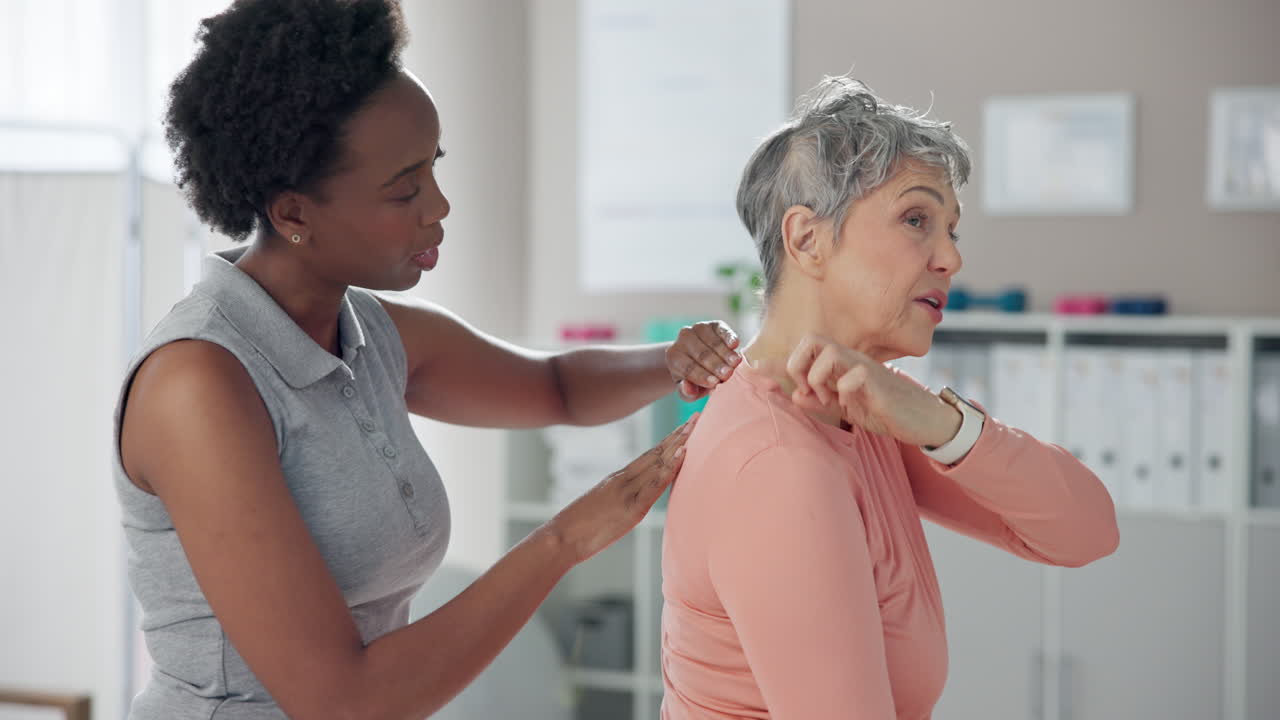 Physical therapist giving neck massage to senior woman