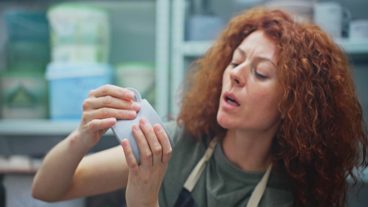 Woman creating pottery in studio