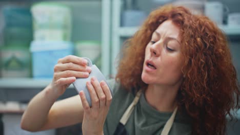 woman creating pottery in studio