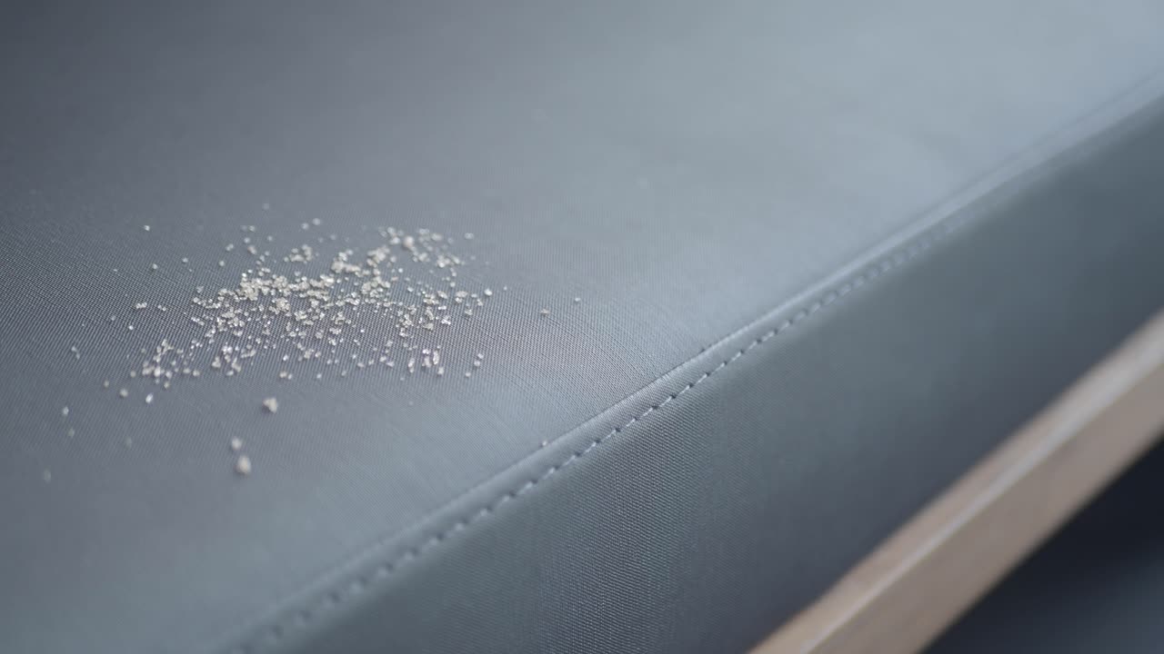 Crumbs on grey fabric surface