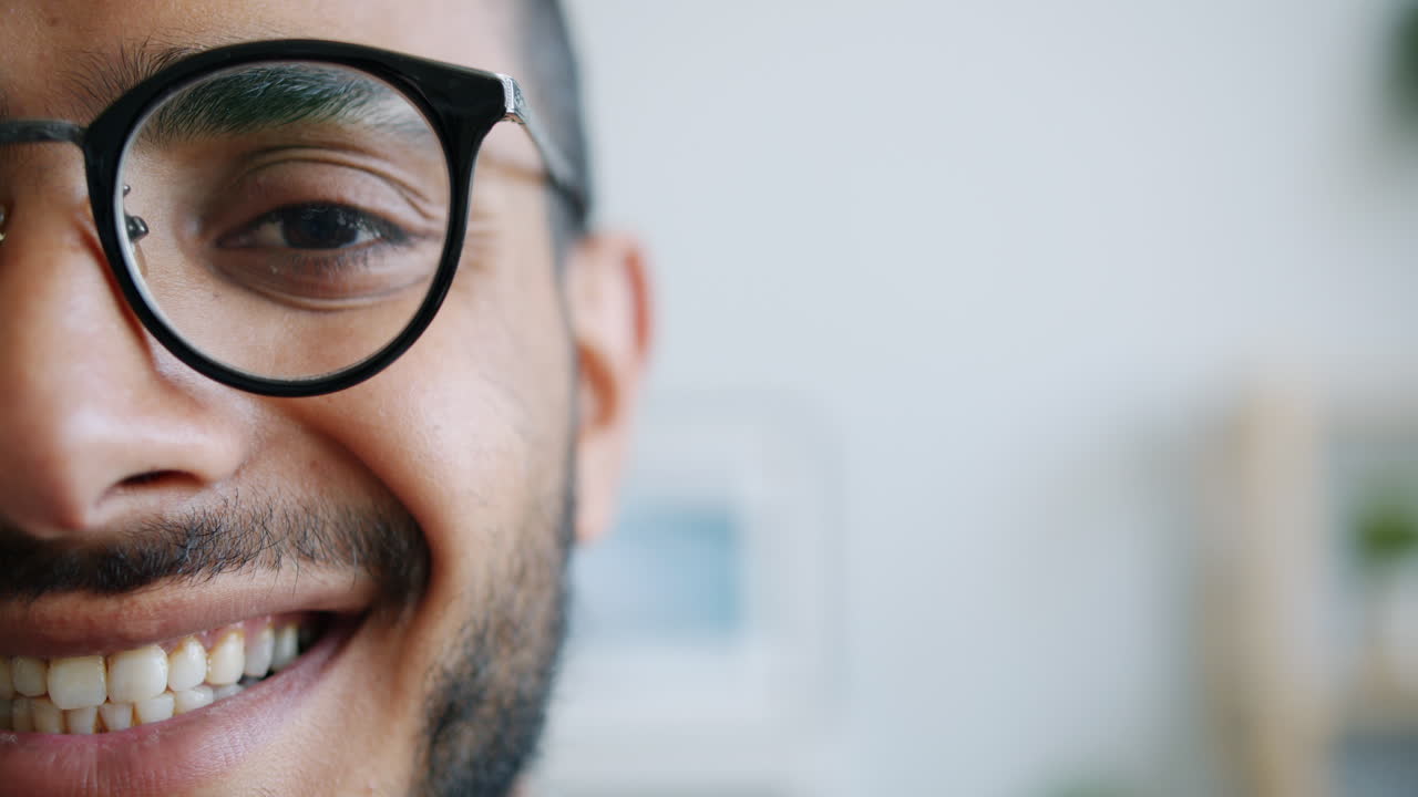 Primo piano di un uomo sorridente con gli occhiali