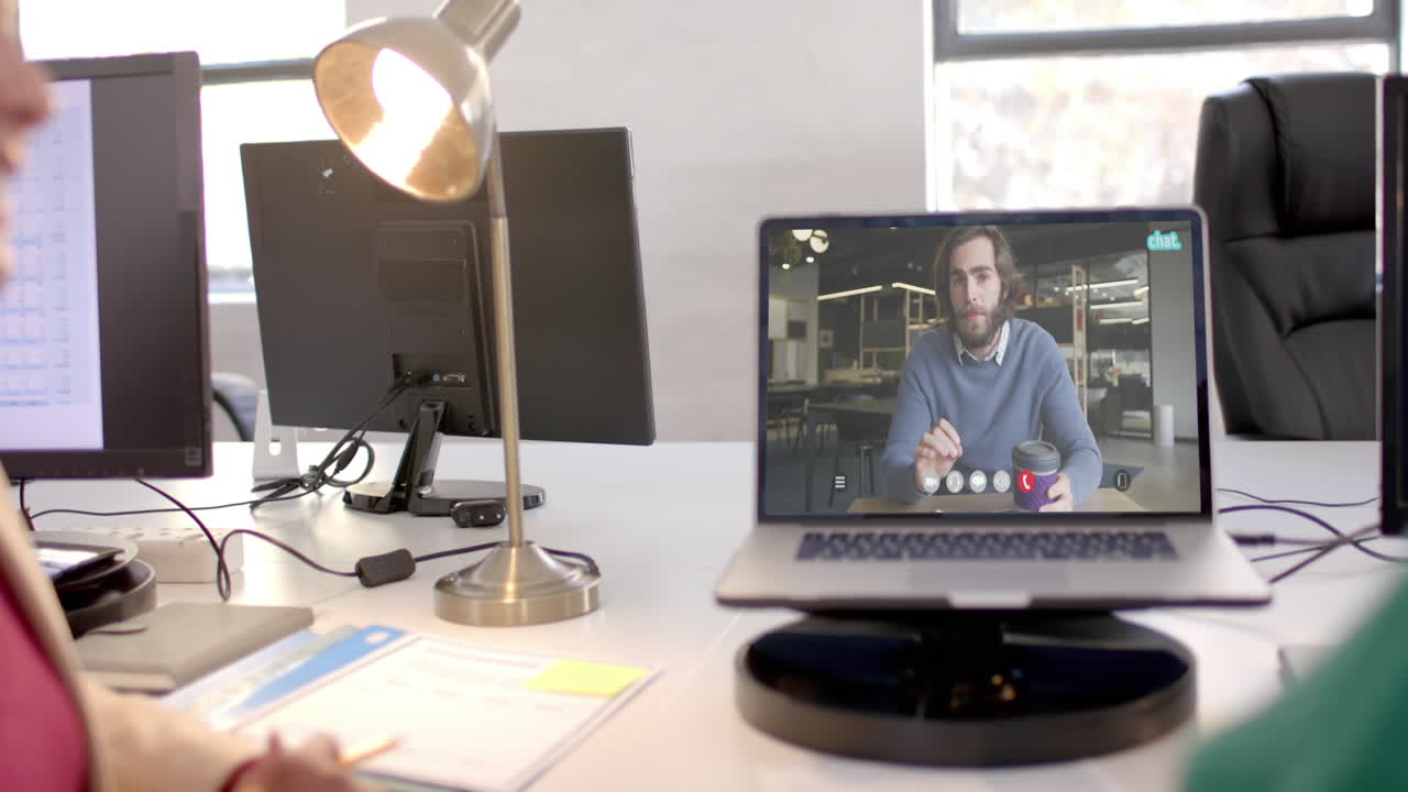 Laptop video call with caucasian male colleague on screen