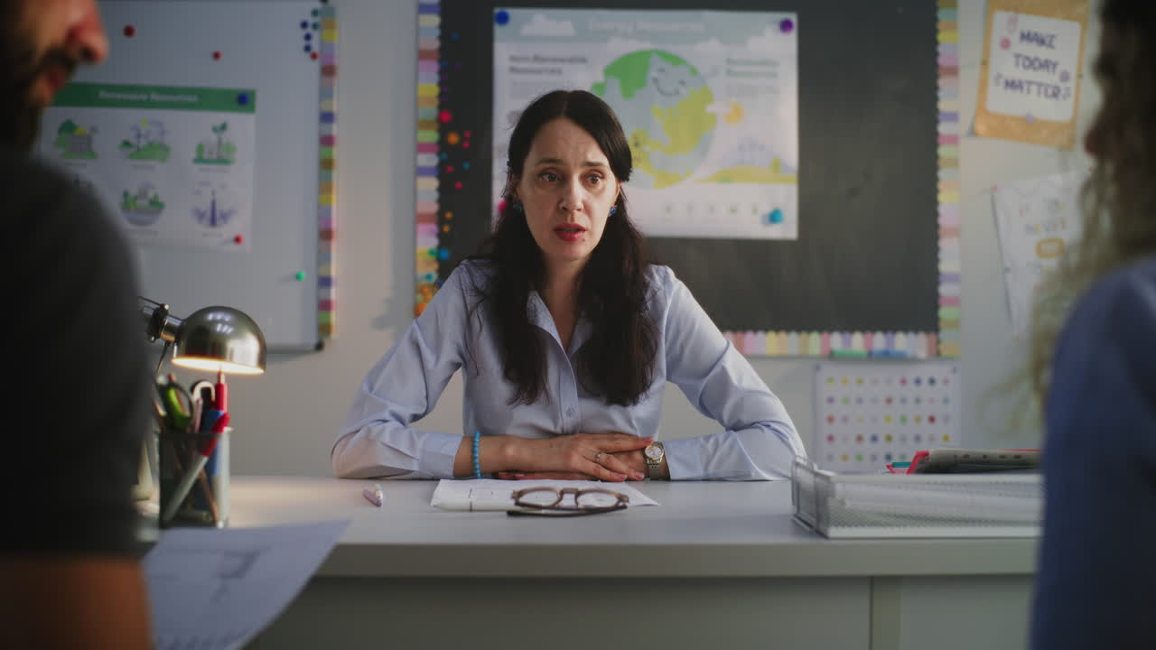 Teacher Meeting with Parents in Classroom