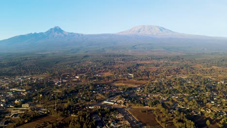 sunrise- kenya landscape with a village, kilimanjaro and amboseli national park - tracking, drone aerial view