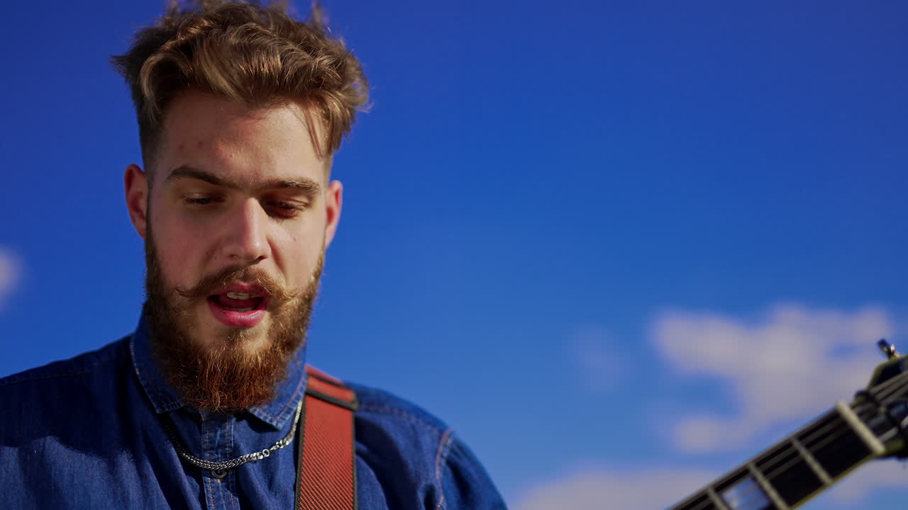 Man playing guitar outdoors