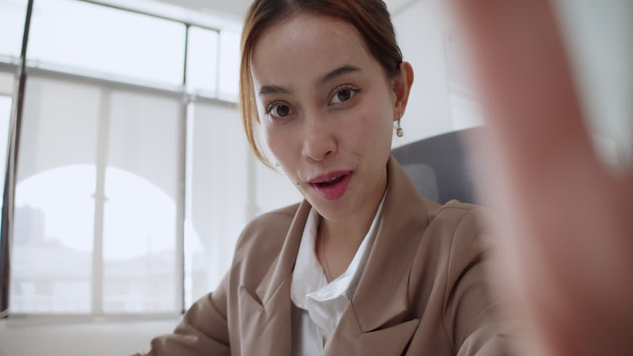 A cheerful professional engages in a business meeting showcasing positivity and collaboration in a bright office setting.