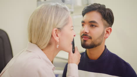 optometrist doing an eye test on a patient